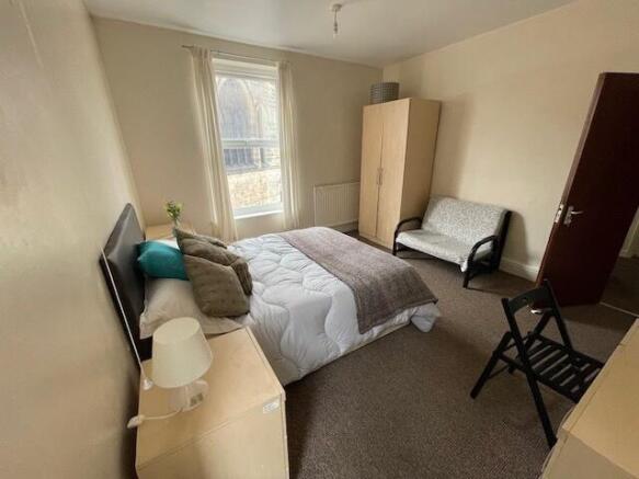 A bright and welcoming double bedroom featuring...