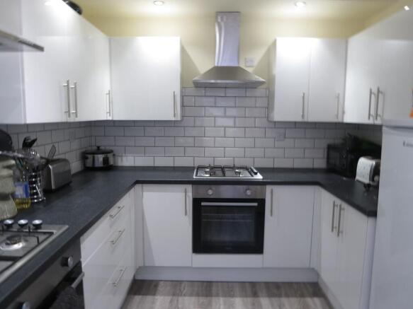 Modern, well-maintained kitchen featuring white...