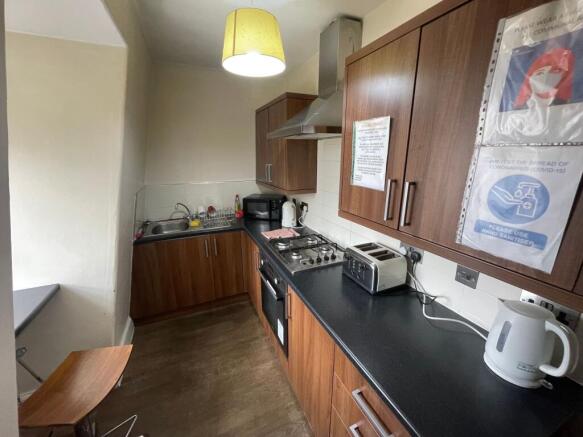A well-equipped kitchen with wooden cabinets, b...