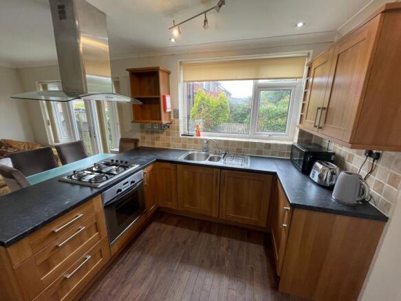 Bright and well-equipped kitchen featuring wood...