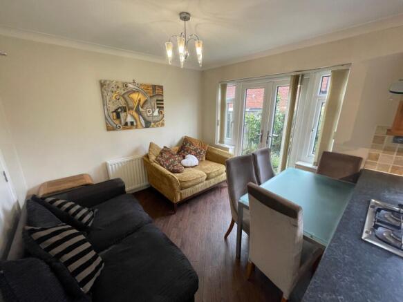 A welcoming living room filled with natural lig...