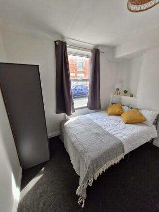 A cozy, well-maintained bedroom featuring a dou...