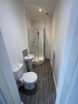 A clean and modern bathroom featuring a curved ...