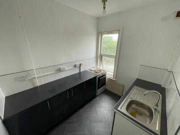 Bright kitchen featuring clean countertops, a m...