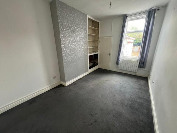 A tidy single bedroom featuring a large window ...