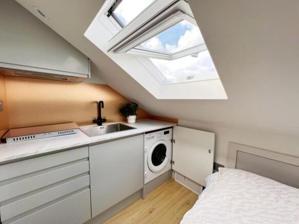 Bright and modern kitchen area with a large sky...