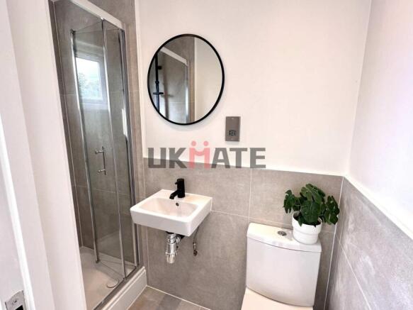 Modern bathroom with a compact shower cubicle, ...
