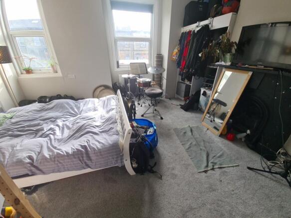 A cozy double bedroom featuring a comfortable b...