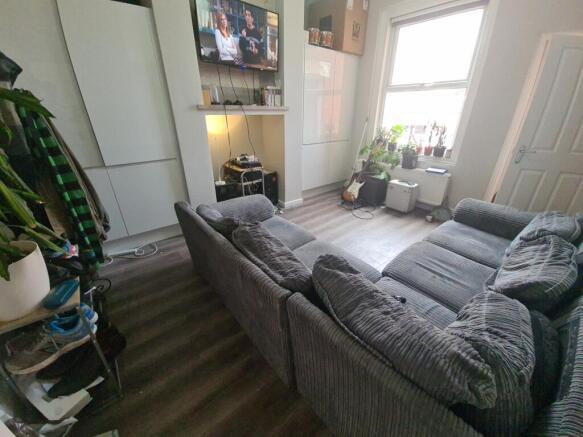 A cozy living room featuring a large comfortabl...