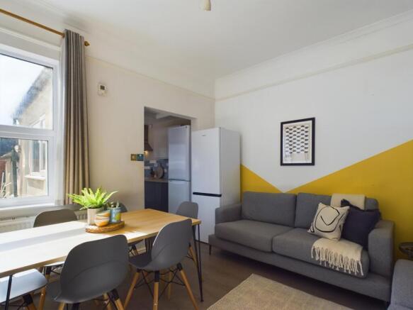 A bright, modern living room featuring a comfor...