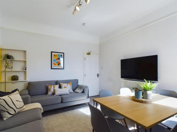 A modern, bright living room featuring a large ...