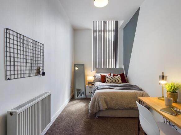 A bright and inviting double bedroom featuring ...