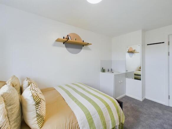 A bright and inviting double bedroom featuring ...