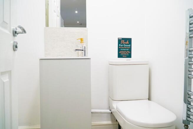 A clean and modern bathroom with a large toilet...