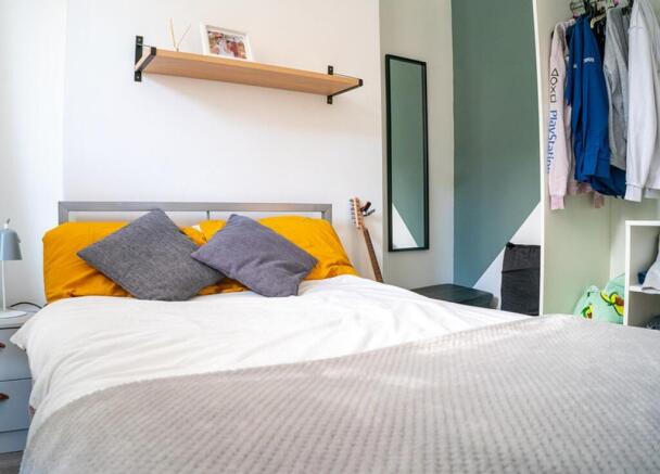 A bright and inviting double bedroom featuring ...