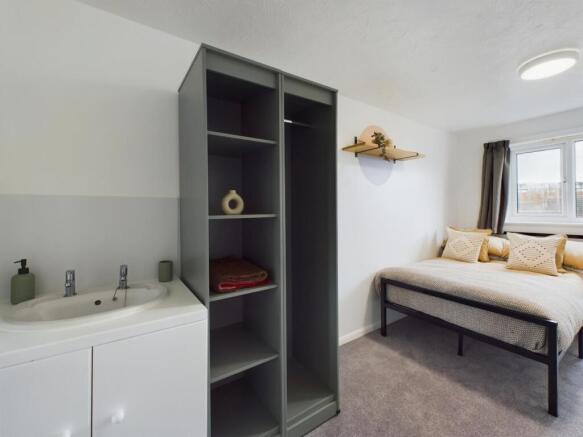 A spacious and well-lit double bedroom featurin...