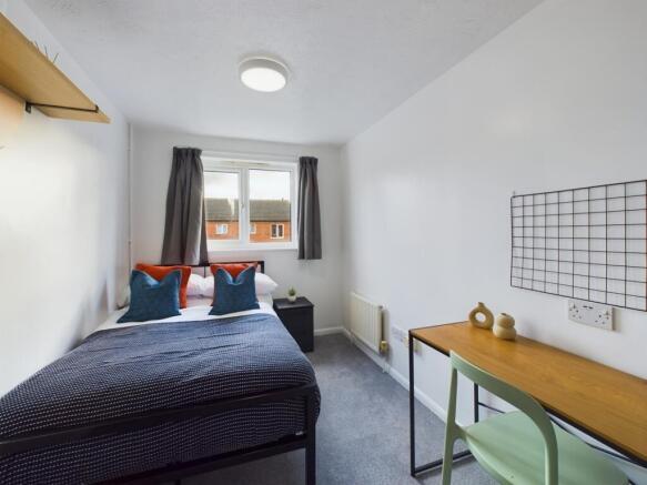 A bright and inviting double bedroom featuring ...