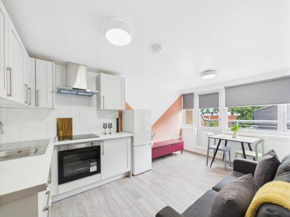 Bright and modern living room featuring large w...
