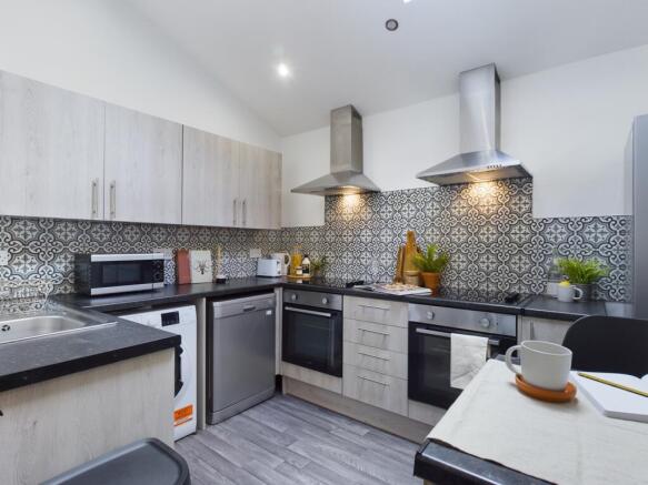 A modern and stylish kitchen featuring sleek ap...