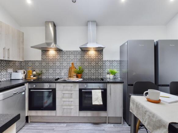 A modern and spacious kitchen featuring stylish...