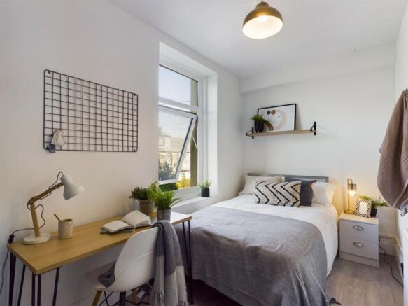 A bright and inviting double bedroom featuring ...