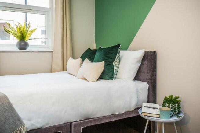 A bright and inviting double bedroom featuring ...