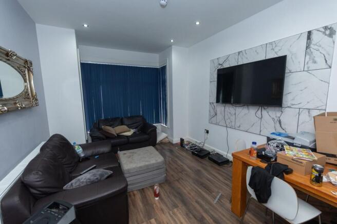 A contemporary living room with two black leath...