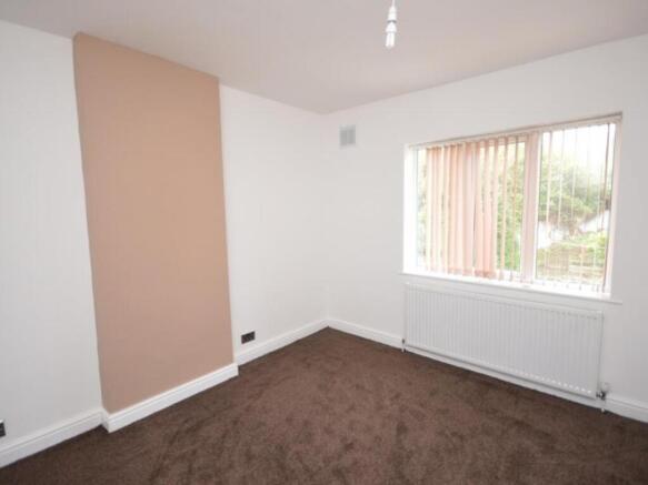 A bright and tidy bedroom with neutral walls an...