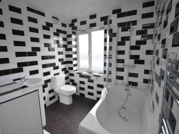 Modern bathroom featuring geometric black and w...