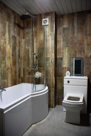 Modern bathroom featuring a large bathtub with ...