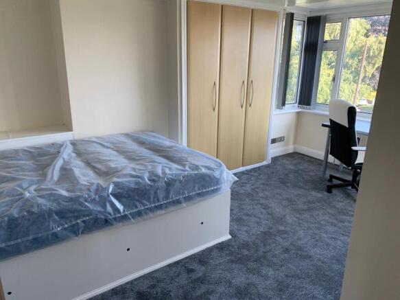 Bright and well-maintained bedroom featuring a ...