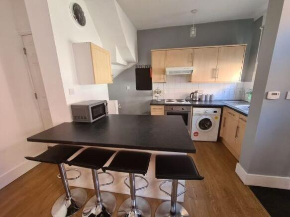 Bright and modern kitchen area featuring a slee...