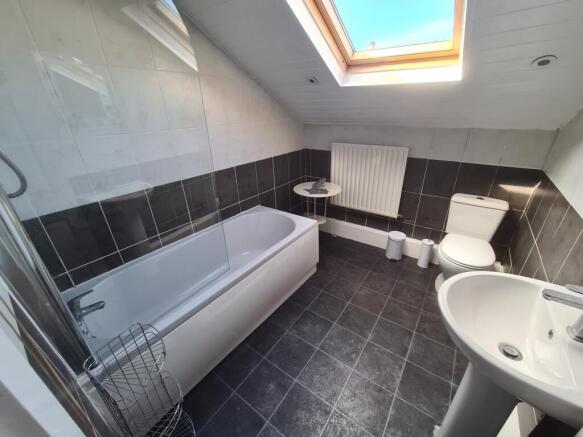 Bright and modern bathroom suite featuring a ba...