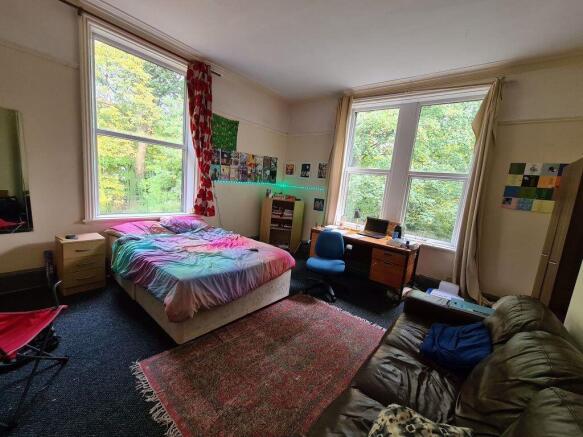 Bright and spacious bedroom featuring two large...
