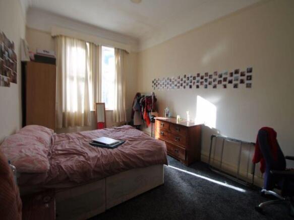 A cozy double bedroom featuring a comfortable d...