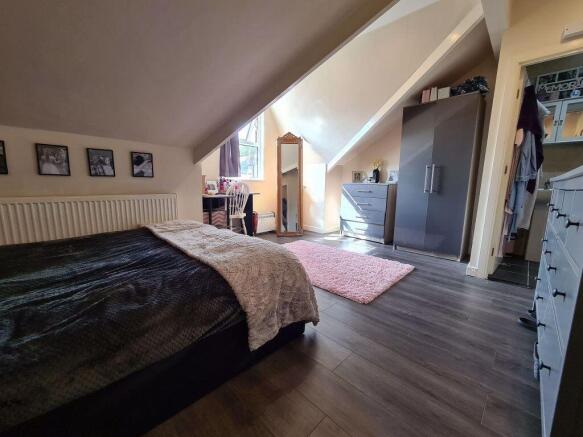 Spacious master bedroom featuring a comfortable...