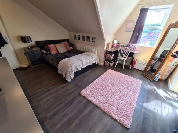 Bright and spacious master bedroom featuring a ...