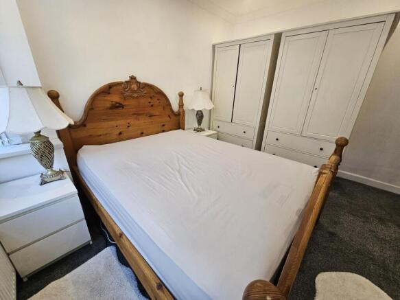 A spacious, well-kept master bedroom featuring ...