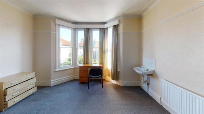 Bright and tidy room with a large bay window al...