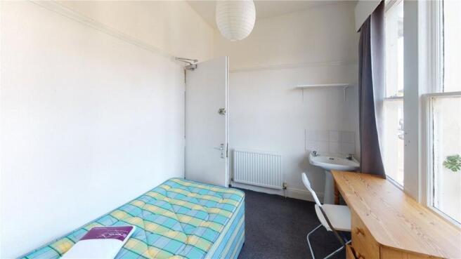 Bright and clean single bedroom featuring a lar...