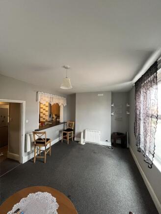 A cozy living room featuring a large window wit...