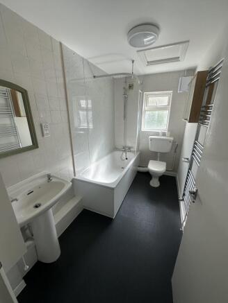Well-maintained bathroom featuring a bathtub wi...