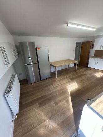 Modern, well-maintained kitchen with wooden flo...