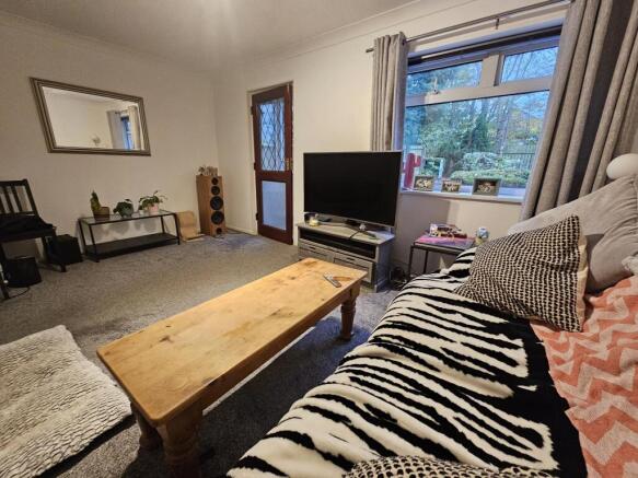A spacious and well-lit living room featuring c...