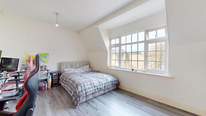 A bright and airy bedroom with a large window a...