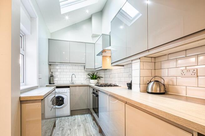 Modern, well-maintained kitchen featuring sleek...