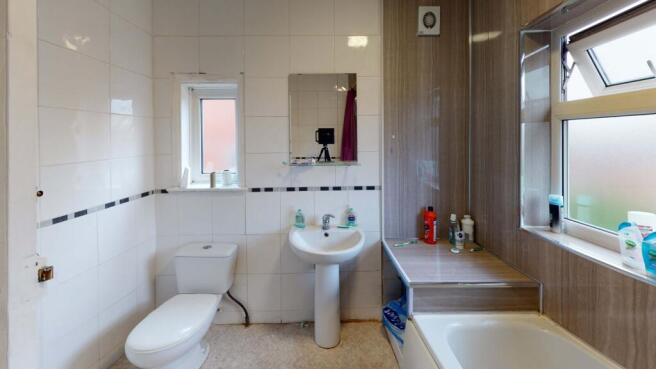 Bright and clean bathroom featuring a large sin...