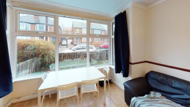 A bright and welcoming living room with large w...