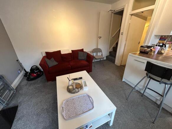 A comfortable living room featuring a red sofa,...