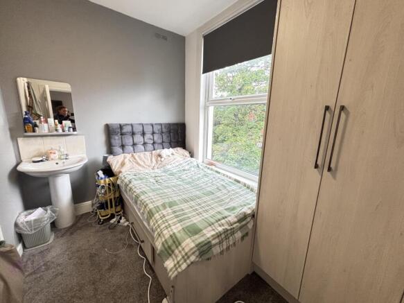 A cozy double bedroom featuring a neatly made b...